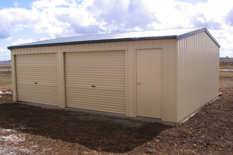 Double cream colorbond garage with doors along length