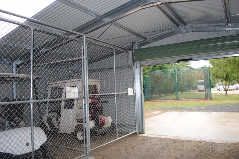 Golf buggy storage shed inside looking out of roller door