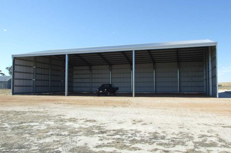 Open front farm shed with beamover openings