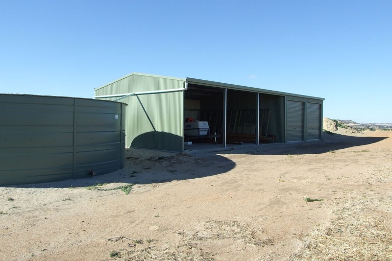 Open front farm shed with two garage bays